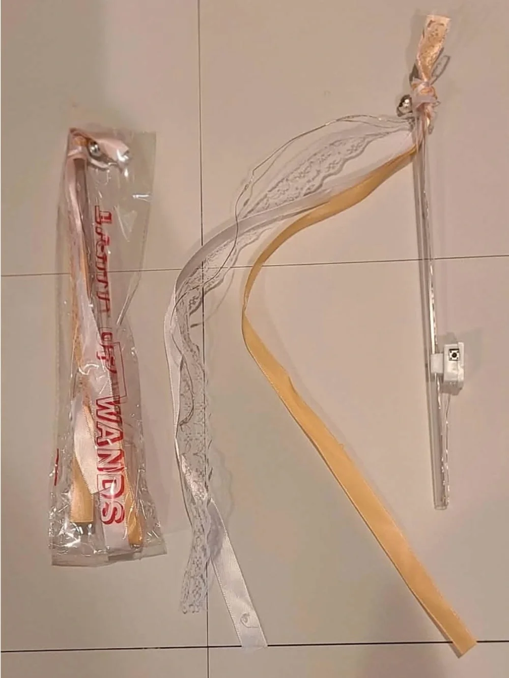 50 individually wrapped LED wands with Champagne ribbon and white lace with bell